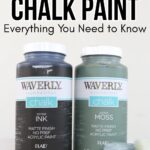 Two jars of Waverly chalk paint in Ink and Moss colors, next to a paint brush on a white surface.