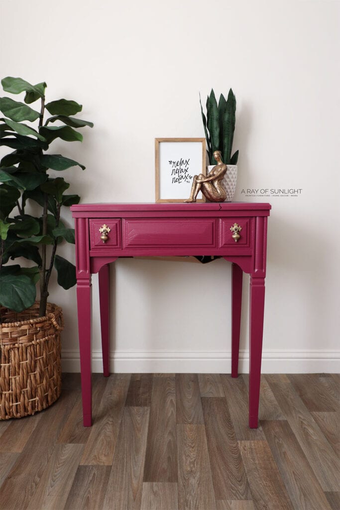 pink painted sewing machine table with gold hardware