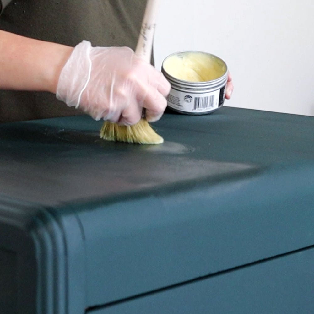 applying wax on furniture with brush