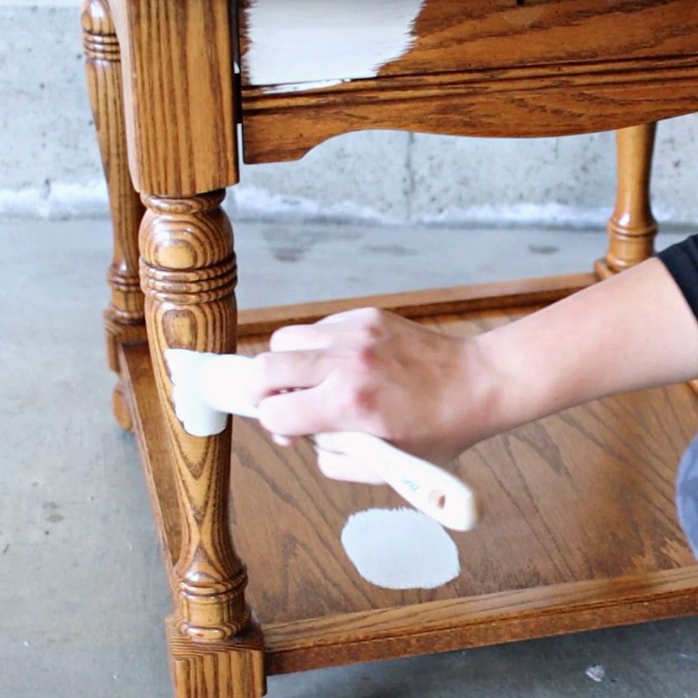 brushing gray paint onto a table