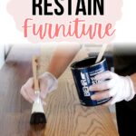 A person stains wooden furniture with a brush; text reads How to Restain Furniture.