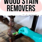 A gloved hand applies wood stain remover to a wooden furniture leg. Text reads: Best Wood Stain Removers.