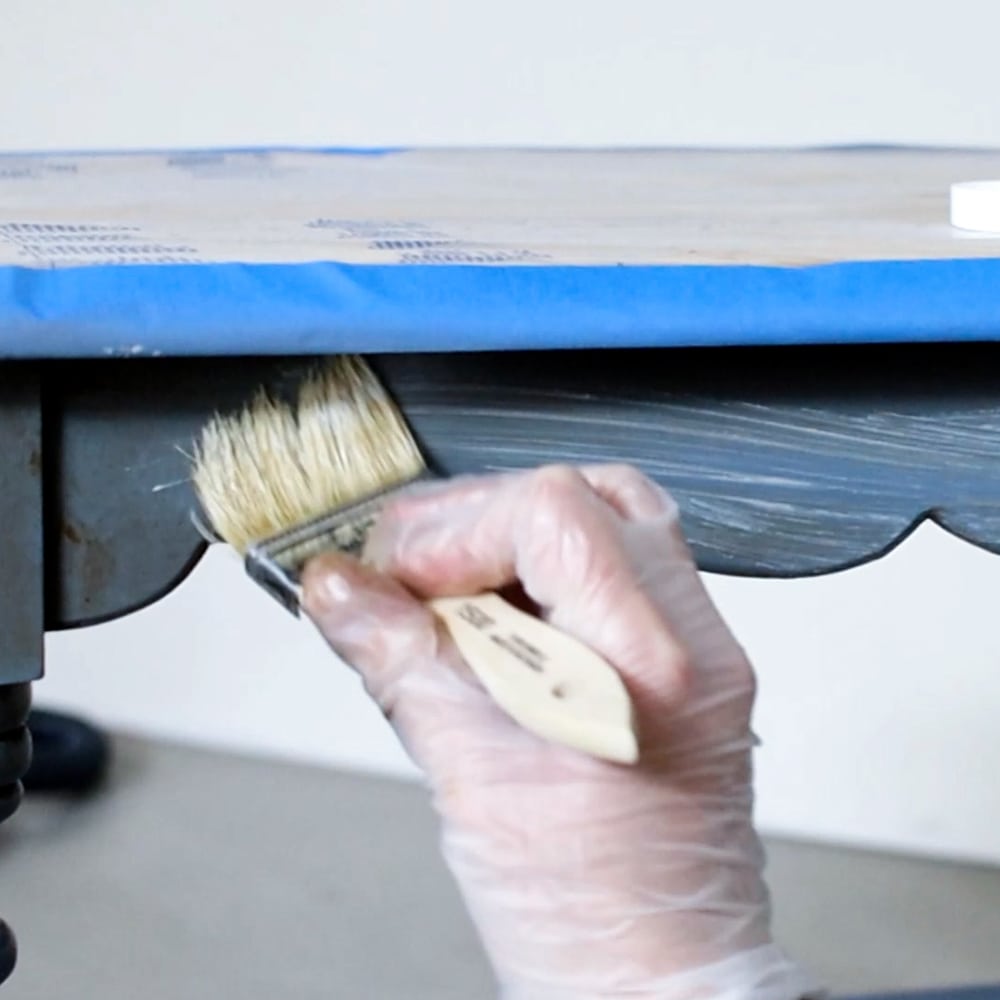 applying waverly wax onto furniture using high quality brush