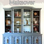 A large blue painted hutch with glass doors and newly painted handles