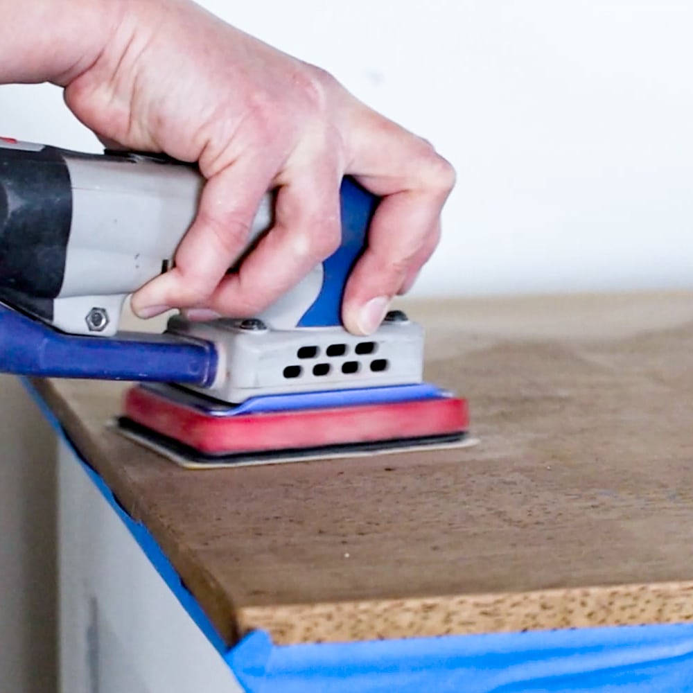 prepping the surface of furniture with surprep sander