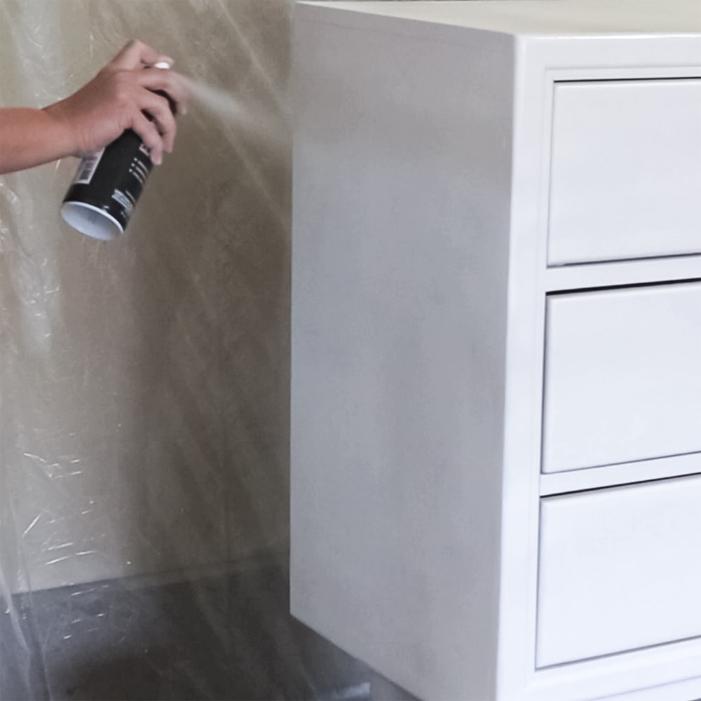 spraying behr spray paint onto furniture