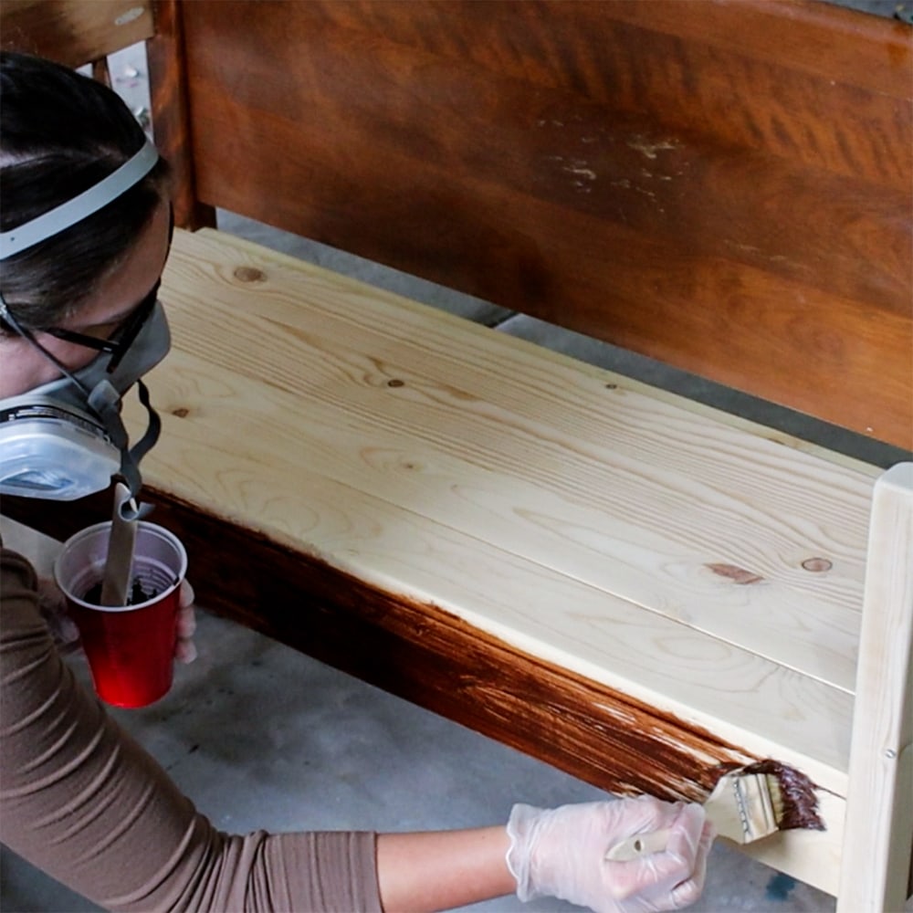 applying stain directly onto the furniture with high quality brush