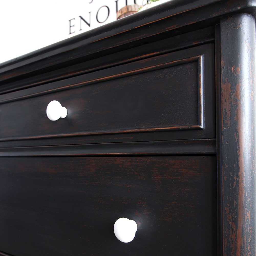 close up view of dresser after painting black showing knobs and distressed paint