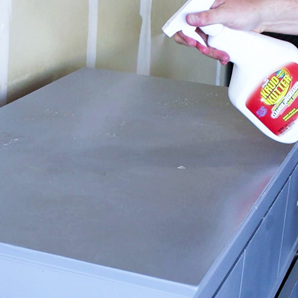 spraying degreaser to clean furniture before painting