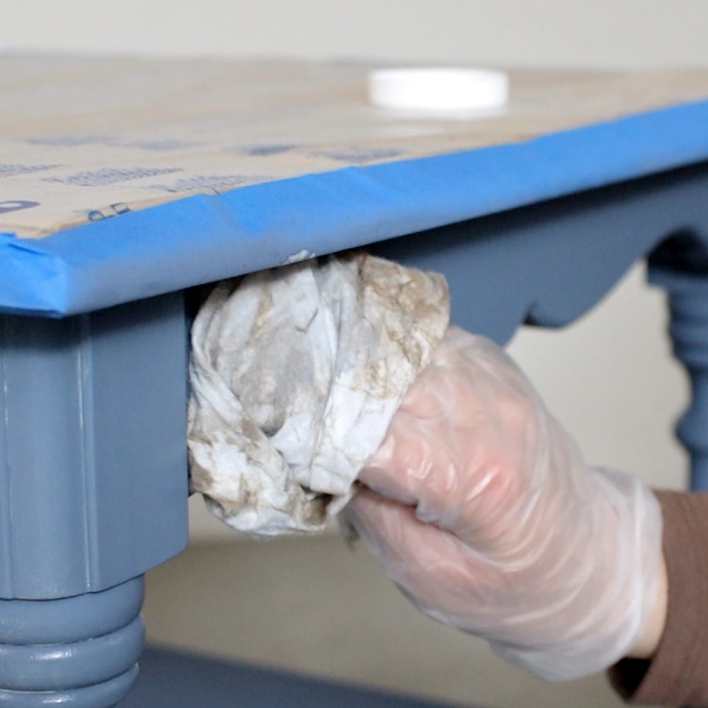 wiping off excess clear wax from furniture