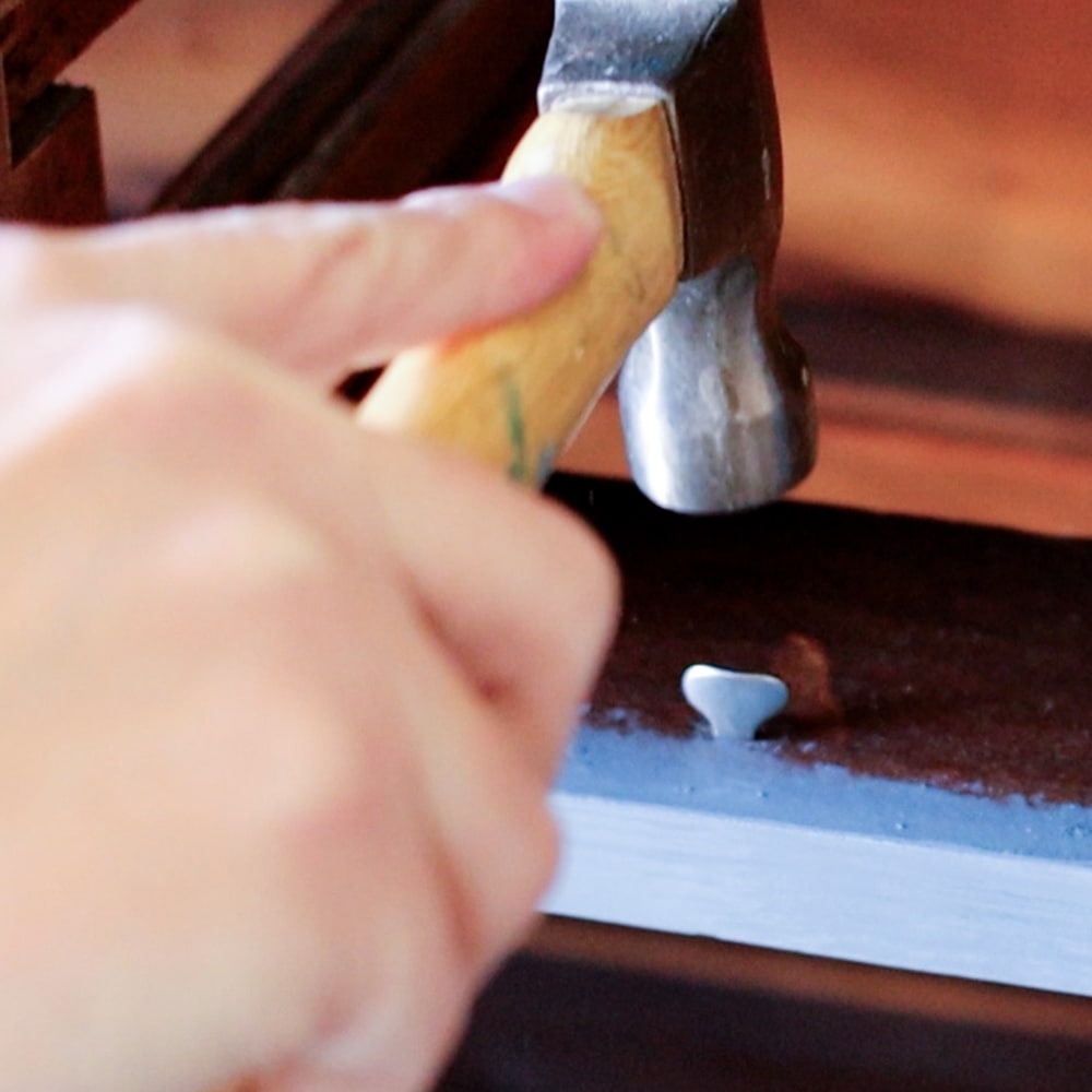 attaching metal drawer stop using a hammer2
