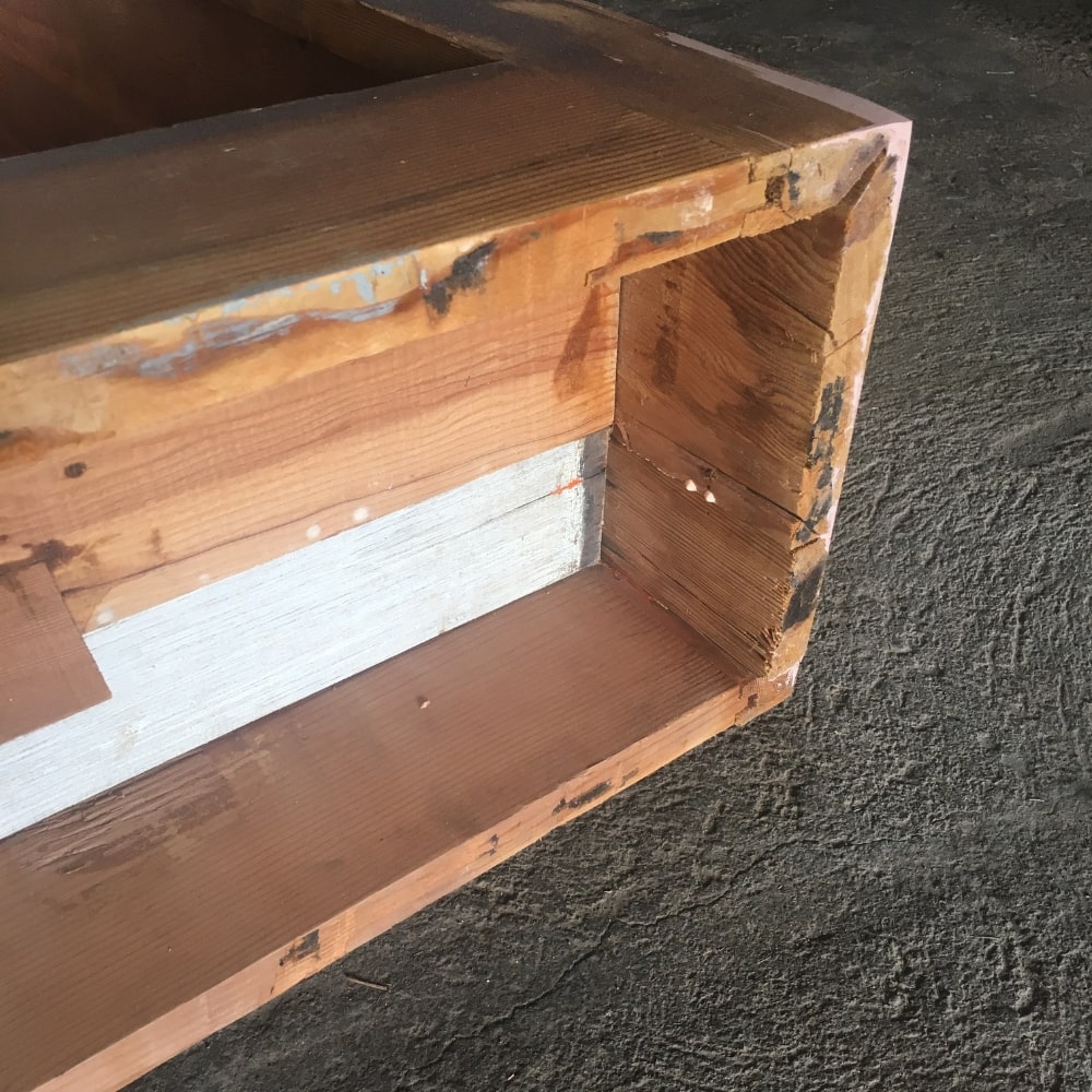 The bottom of a cabinet before adding new legs