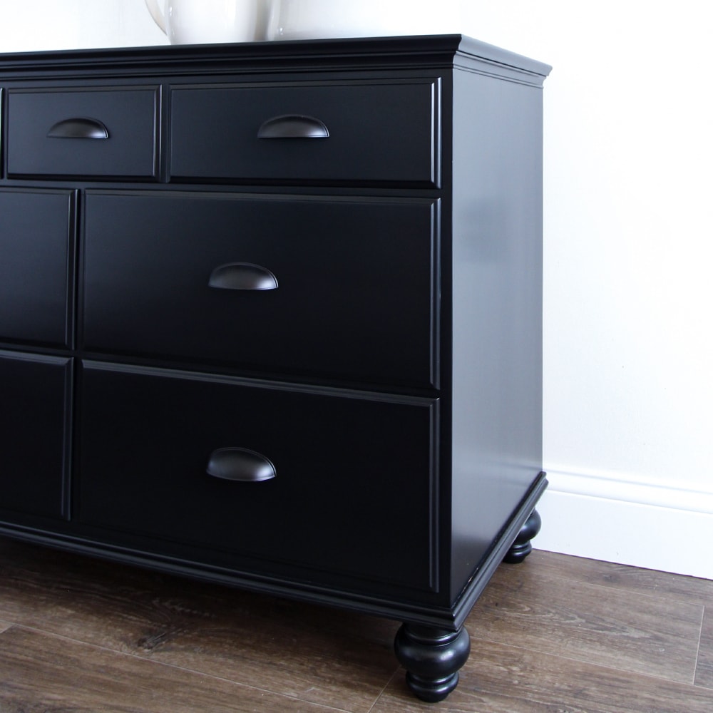 closeup of black painted dresser with new black legs and black cup pulls