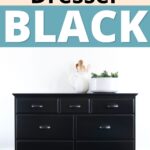 A black dresser with decor on top, against a white wall with text: Painting a dresser black.