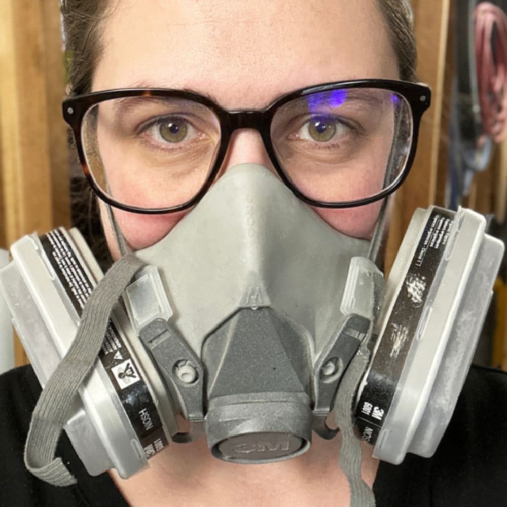  wearing a respirator before spraying polyurethane
