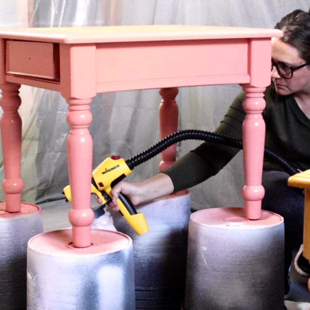 Using a paint sprayer to paint end tables with chalk paint