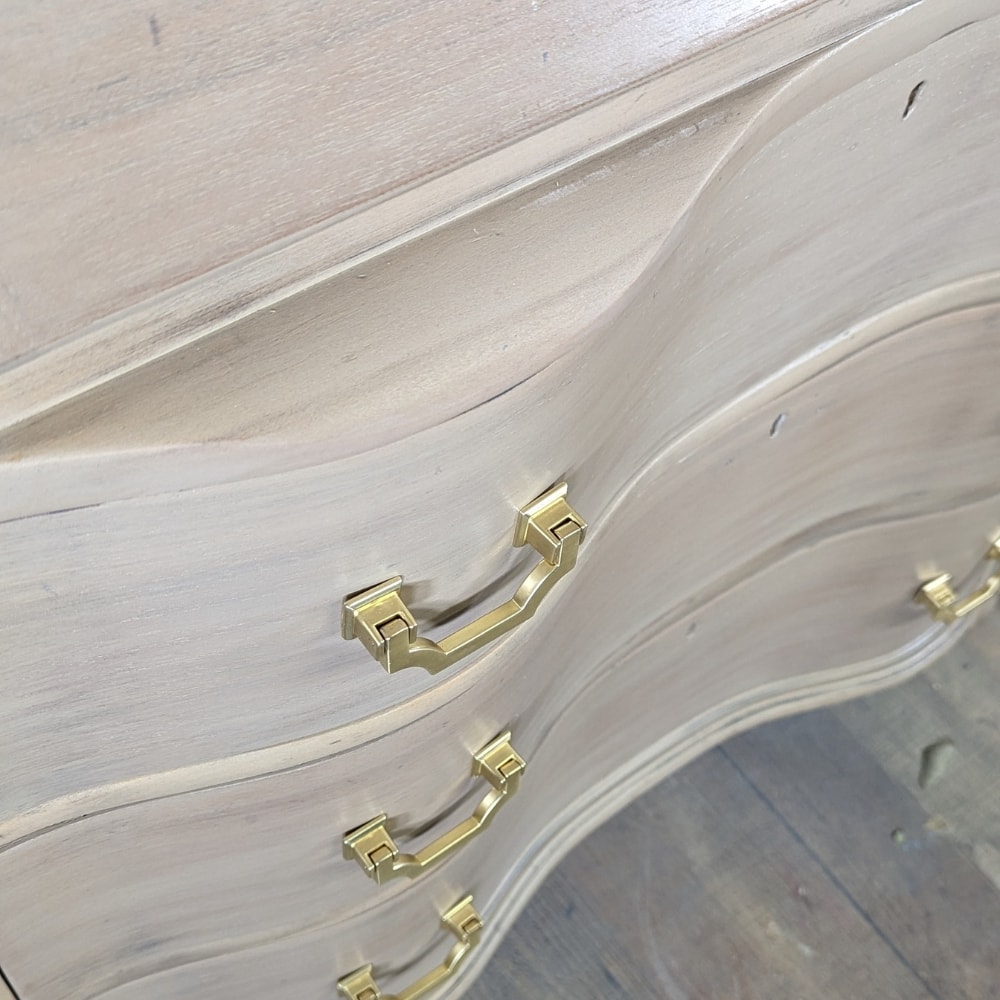 closeup of the refinished desk with new gold pulls