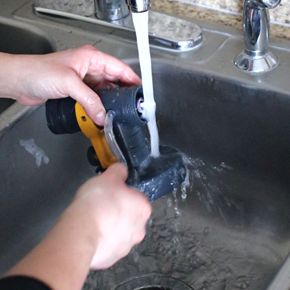 cleaning spray nozzle under running water after use to prevent clogs