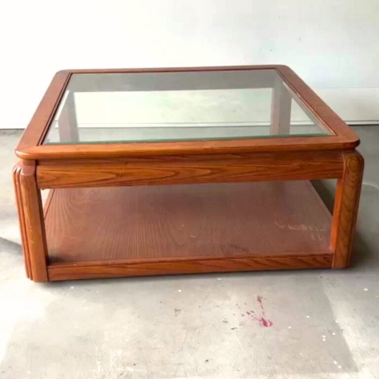 square coffee table with glass top and orange finish