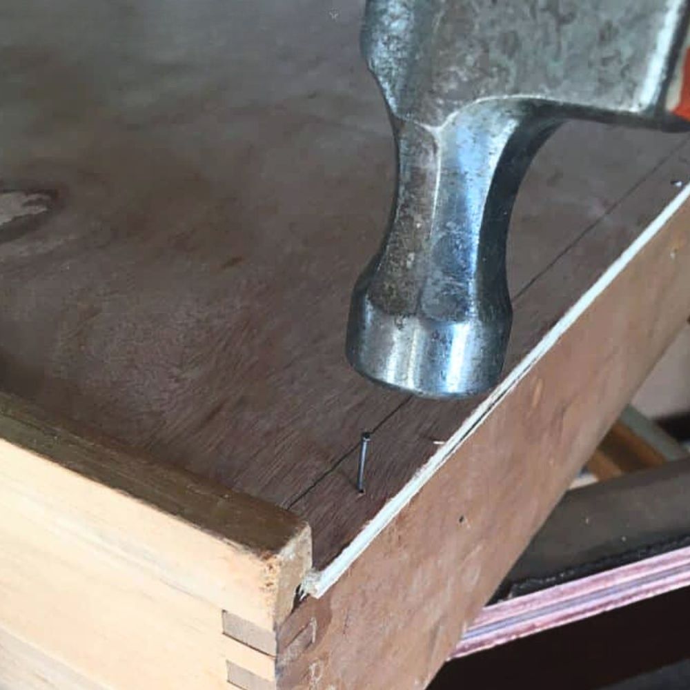 photo of adding nails to the drawer bottom
