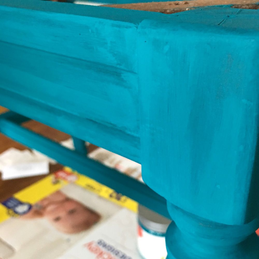 photo of wood bench with first few coats of blue paint applied