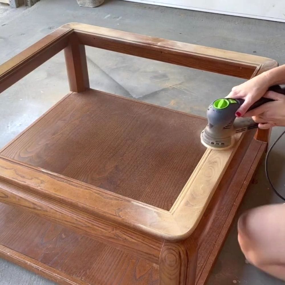 using a power sander to remove the old stained wood finish