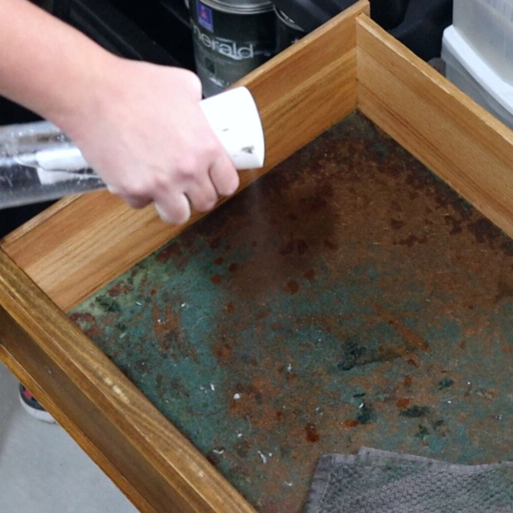 spraying drawer bottom with hot water before removing felt