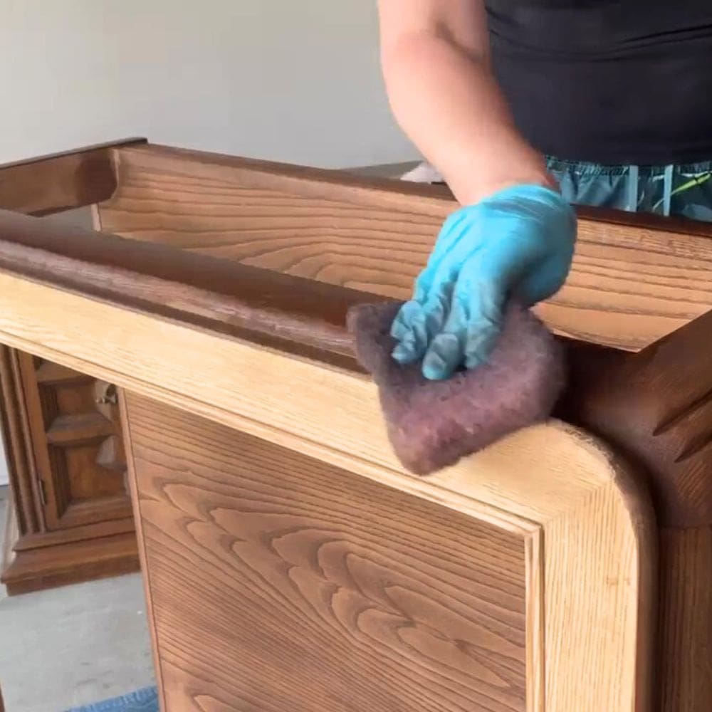 using a stain pad to stain another part of the coffee table