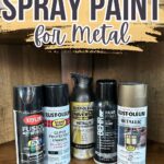 Five cans of spray paint for metal are lined up under text reading “Best Spray Paint for Metal.”.