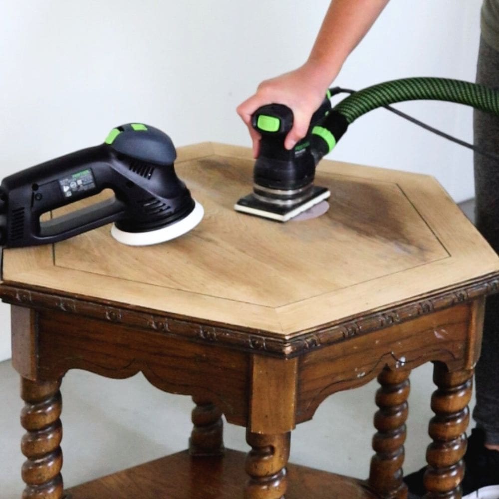 comparing two festool sanders while sanding the finish off an end table