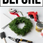 Green wreath, glue gun, ribbon, wood stain, pliers, foam brush, and felt arranged on white surface.