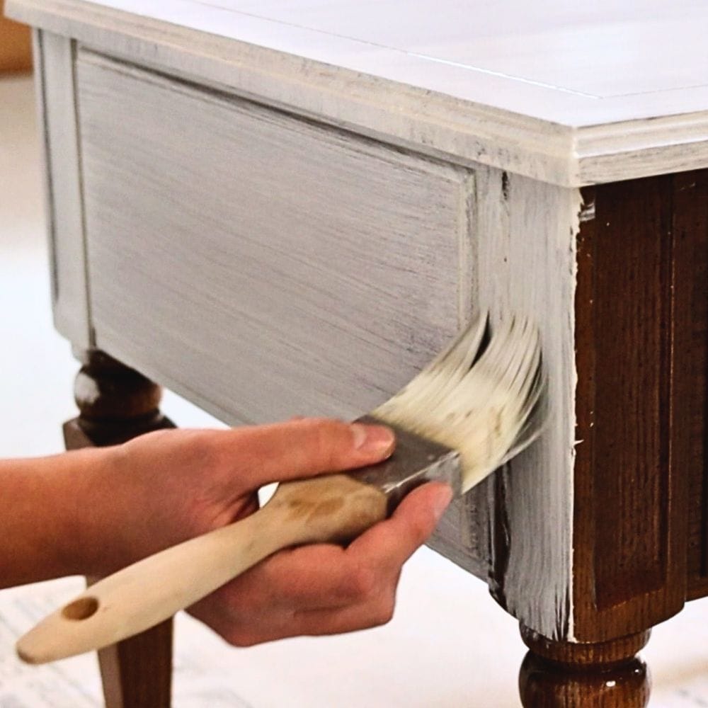 photo of painting acrylic paint onto furniture with a paint brush