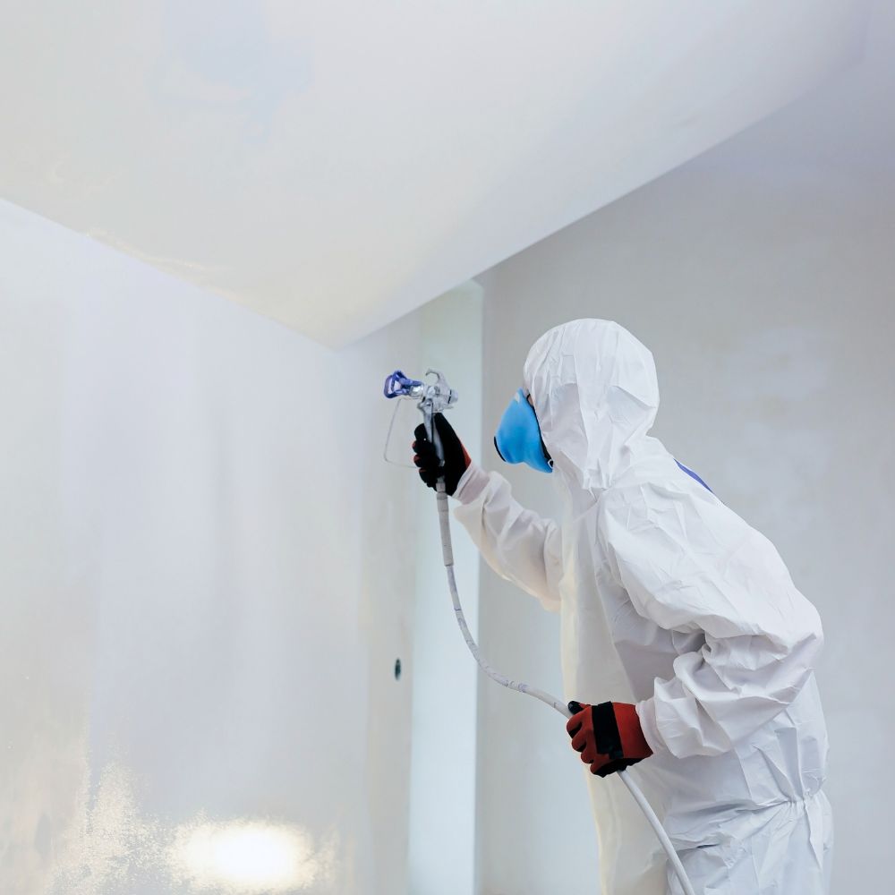 photo of painting walls with airless paint sprayer
