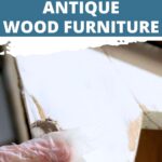 Gloved hand applying filler to cracks in damaged antique wood furniture, with repair instructions above.