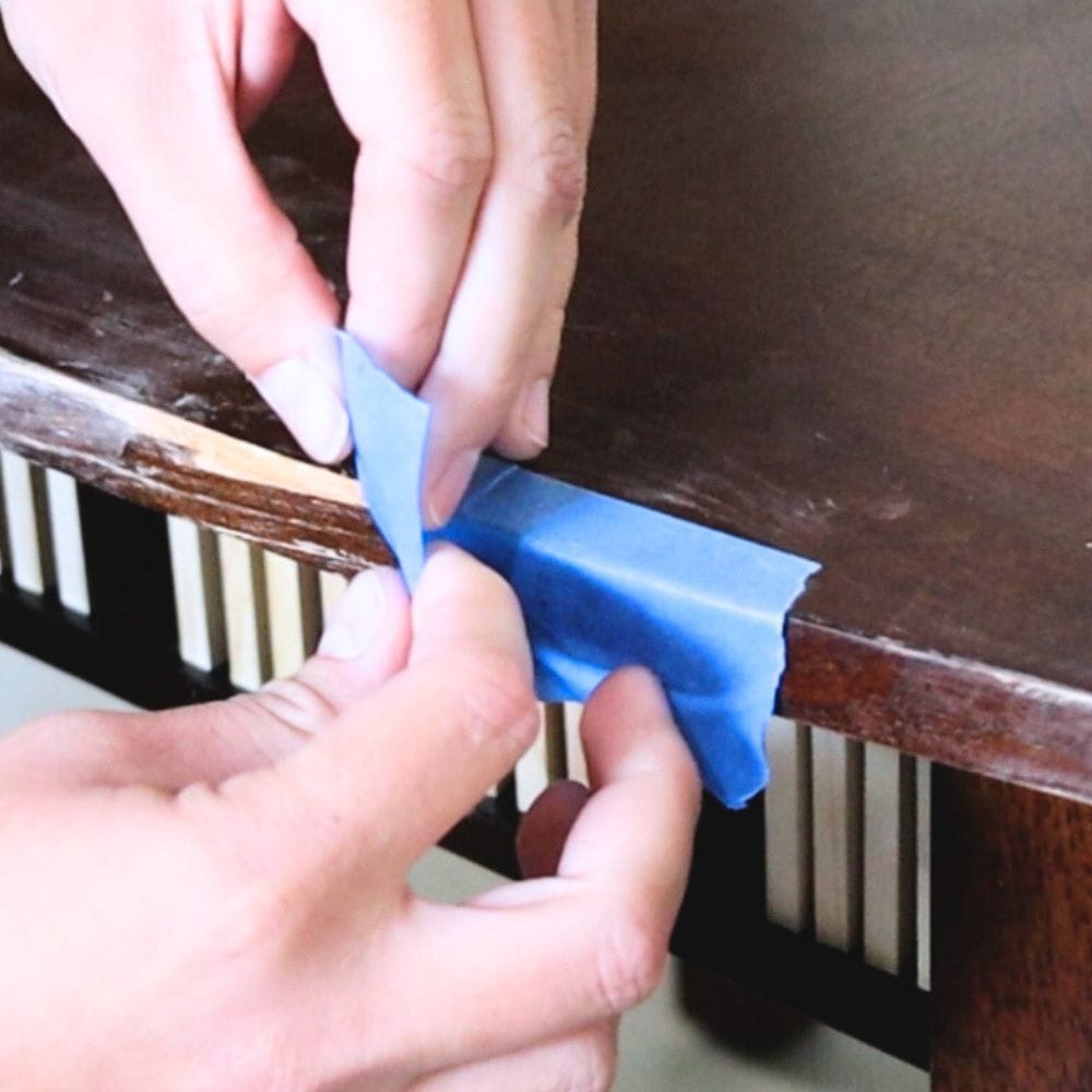 using painters tape to help secure repaired veneer