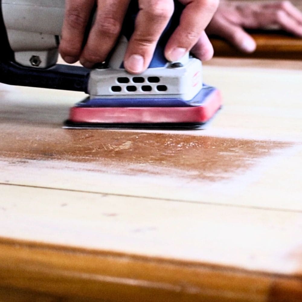 Photo of sanding wood filler on furniture