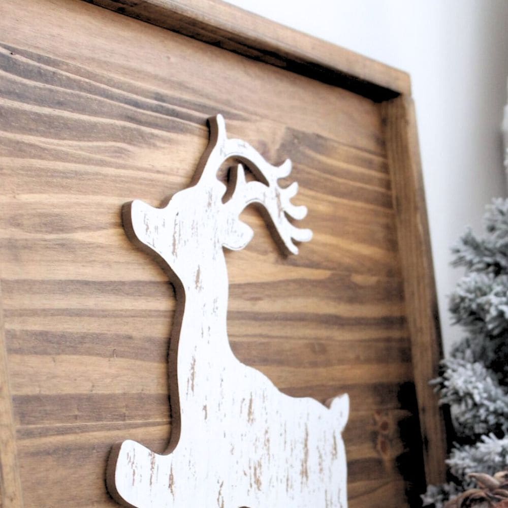 close up view photo of DIY Reindeer Christmas Sign showing stained board and furring strips