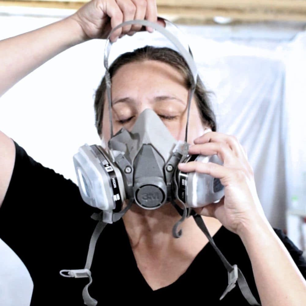 photo of donning a respirator before painting