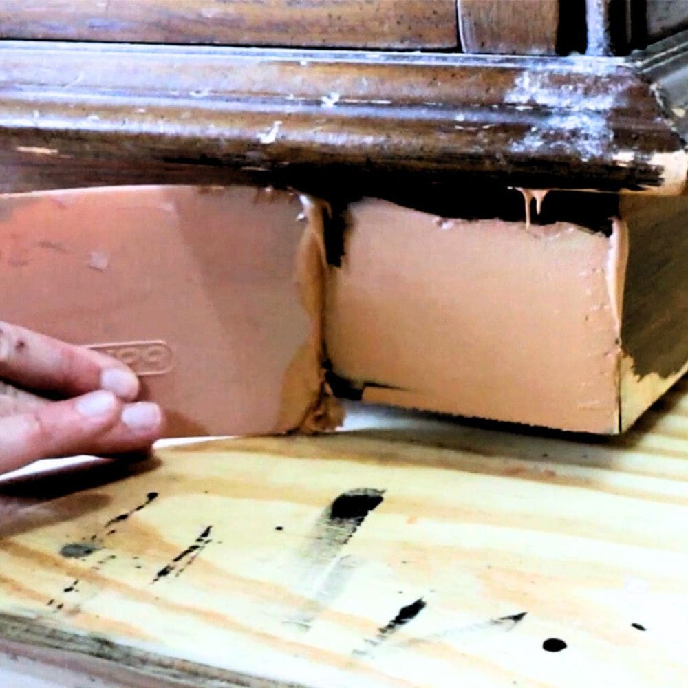 photo of applying bondo to damaged veneer