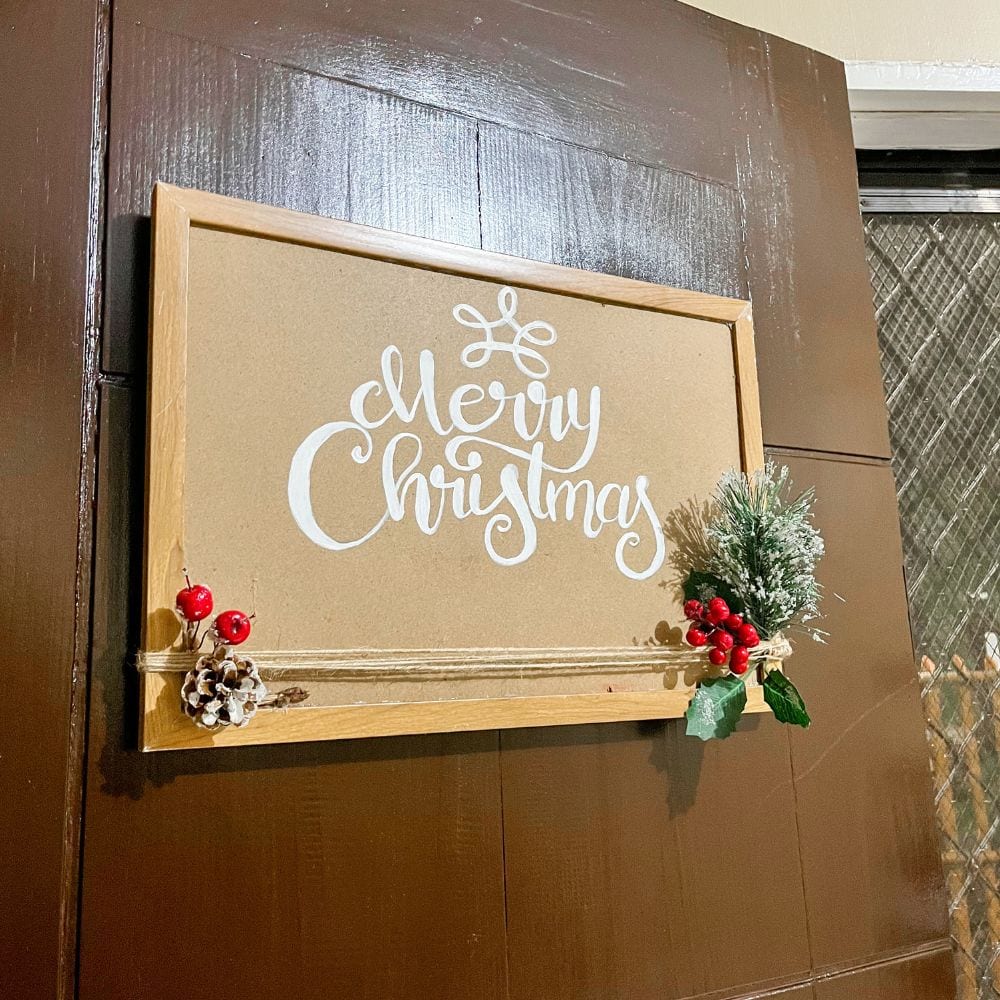 photo of hanging merry christmas wall sign outdoors