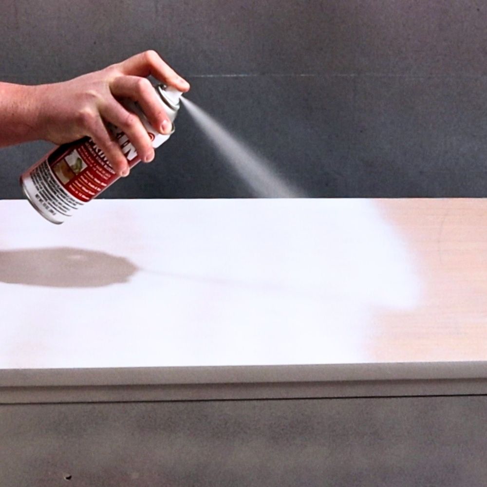 photo of spraying primer onto dresser