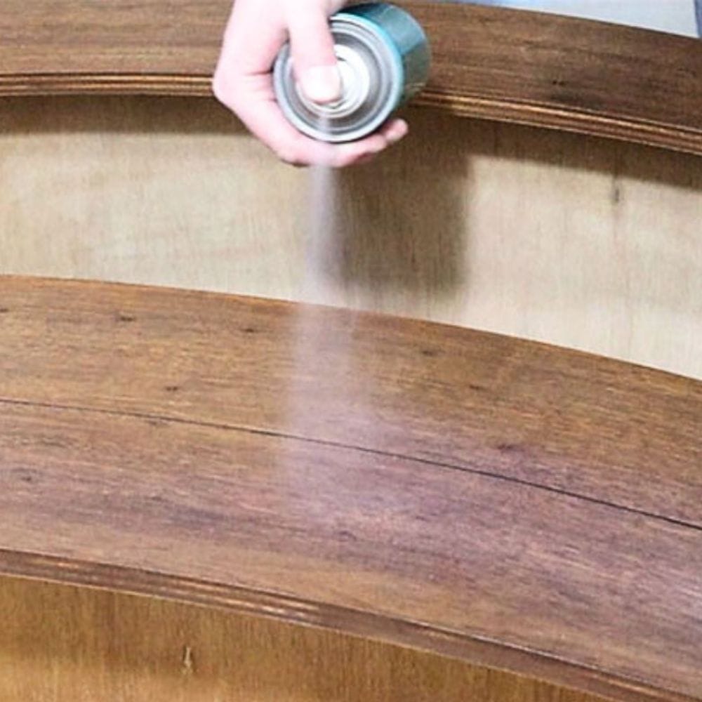 spraying Minwax Polycrylic Protective Finish Spray to wood furniture