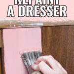 Hand painting a wooden dresser with pink paint and a brush, with text How to Repaint a Dresser above.