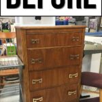 A wooden dresser with four drawers and gold handles before makeover