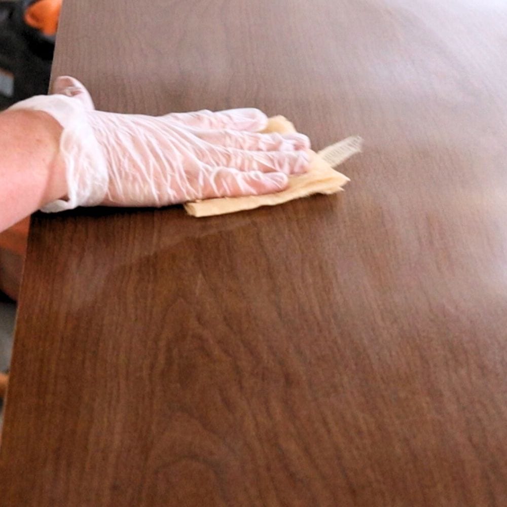 Photo of using tack cloth to remove dust from sanding
