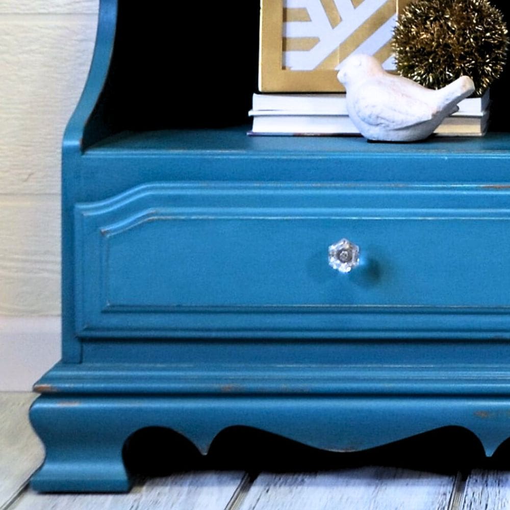 close-up view of new knobs and distressed corners on teal blue nightstands