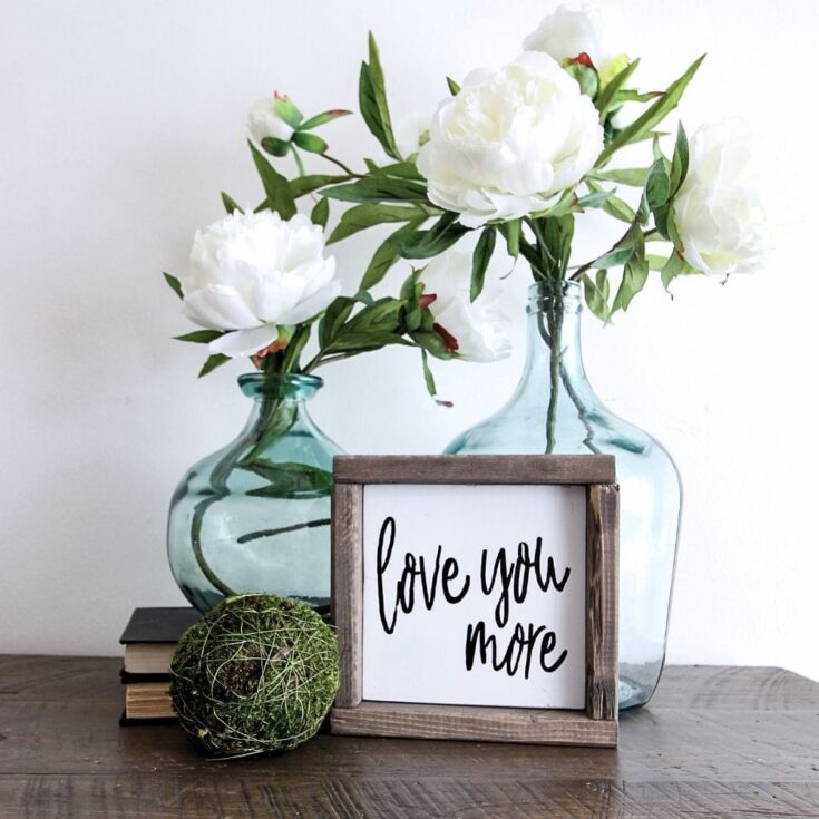 photo of i love you more wooden sign