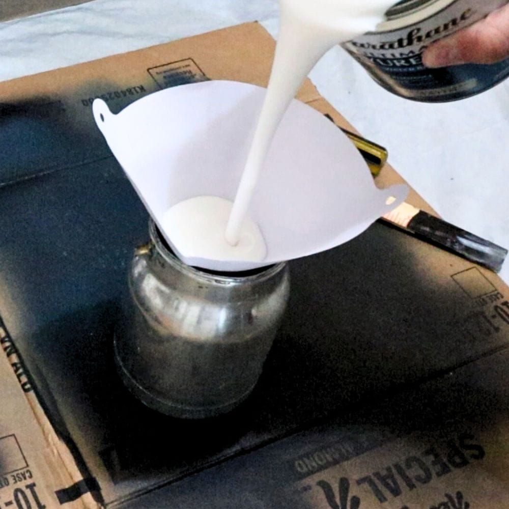 photo of pouring Varathane polyurethane into paint sprayer