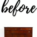A wooden sideboard against a white wall with the word before written in large script above it.