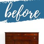 A dark wooden sideboard stands below a large before sign on a white wall with blue paint accents.